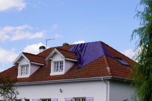 roof needs repairs covered with a tarp waiting